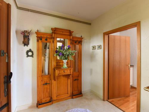 a hallway with a vase of flowers on a cabinet at Holiday Home Andrea by Interhome in Brseč