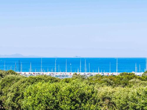 a bunch of boats parked on a beach with the ocean at Apartment Il Veliero by Interhome in Punta Ala