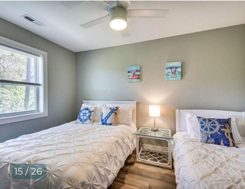 a bedroom with two beds and a window at Puttin Around in Kitty Hawk