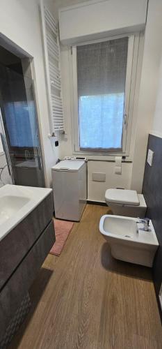 baño con 2 aseos y ventana grande en A Casa Di Viola, en Casalecchio di Reno