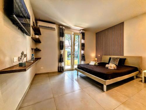 a bedroom with a bed and a large window at - La Grotta del Mare- Beach and Apuan Alps- in Marina di Carrara