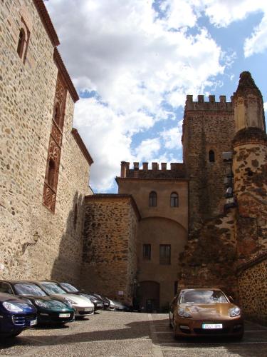 a group of cars parked in front of a castle at Hospederia del Real Monasterio in Guadalupe