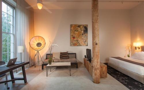 a bedroom with a bed and a desk and a chair at Loft 523 in New Orleans