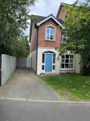 a brick house with a blue door on a street at Stunning semi-detached townhouse, Holywood, Sleeps 6 - 10 mins from Belfast in Belfast