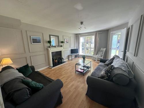 a living room with two couches and a fireplace at Stunning semi-detached townhouse, Holywood, Sleeps 6 - 10 mins from Belfast in Belfast