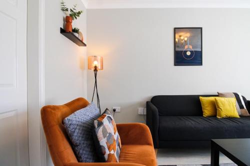 a living room with a couch and a chair at Host & Stay - Wilshire Way in Milton Keynes