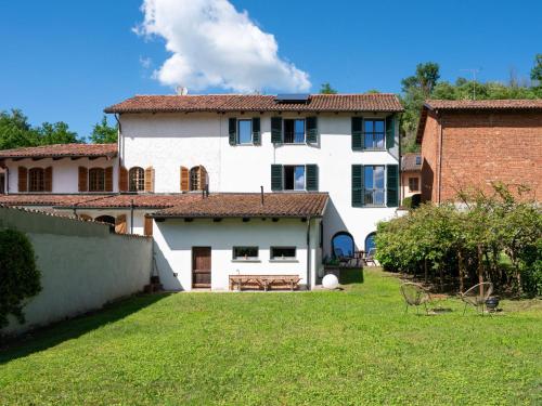 a large white house with a yard in front of it at Holiday Home Beppe Country House by Interhome in Serravalle dʼAsti