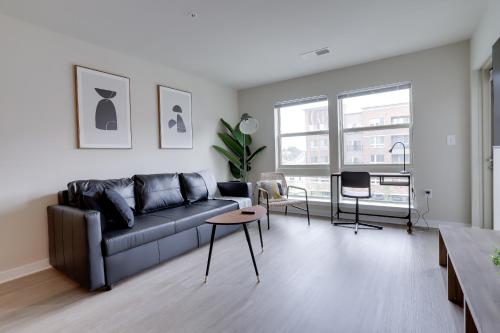 a living room with a couch and a table at Charming Condo with Nice Amenities at Alexandria in Alexandria