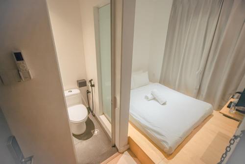 a small bathroom with a toilet and a window at Double H Boutique Hotel in Kuala Terengganu
