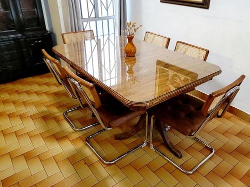 a dining room table with chairs and a vase on it at COZY CASITA EN PLAYAS DE TIJUANA in Tijuana