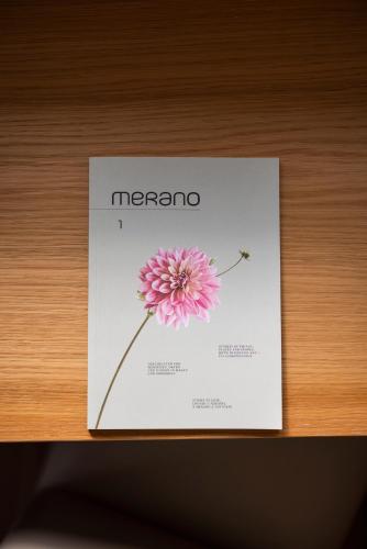a paper with a picture of a flower on a shelf at Weingarten Terlan - Rooms & Breakfast in Terlano