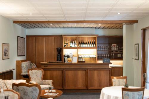 a bar in a restaurant with a counter and chairs at Weingarten Terlan - Rooms & Breakfast in Terlano