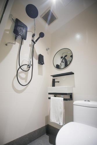 a bathroom with a shower and a toilet at Double H Boutique Hotel in Kuala Terengganu