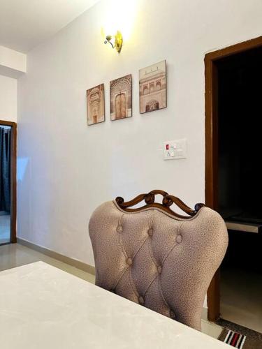 a chair sitting at a table in a room at Ajnara 2 in Varanasi