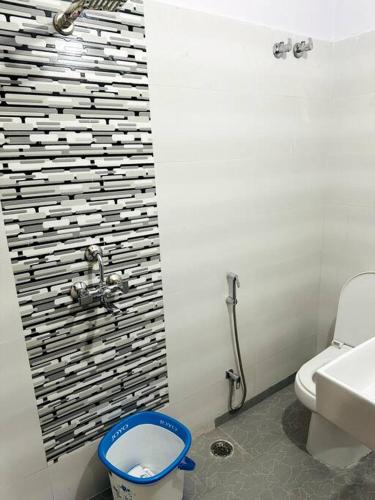 a bathroom with a toilet and a sink at Ajnara 2 in Varanasi