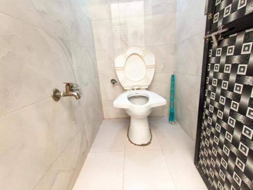 a bathroom with a toilet and a shower stall at Jay Kuber Home stays in Garudeshwar