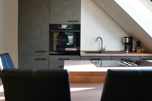 a kitchen with a sink and an oven at Old Mill House in Bohinj