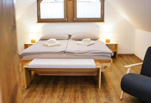 a bedroom with a bed with two towels on it at Old Mill House in Bohinj