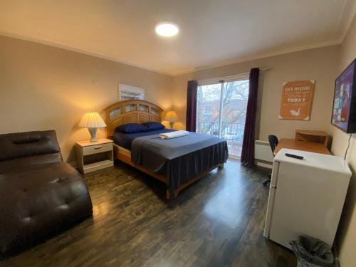 a bedroom with a bed and a chair and a window at MontREAL HOMES - Affordable Rooms, Smart TV, Shared Kitchen in Montréal