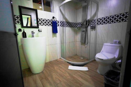 a bathroom with a shower and a toilet at Hotel Villas Tiburon Adults Only in Holbox Island