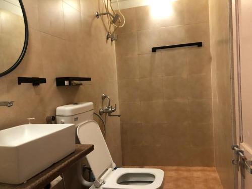 a bathroom with a toilet and a sink and a shower at NILAY House Varanasi Near Assi Ghat in Varanasi