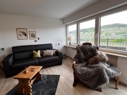 a living room with a couch and a table at Weingut Bastian in Brauneberg