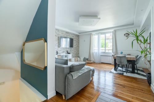 un salon avec un canapé et une table dans l'établissement Magnificent duplex in Dugny, à Dugny