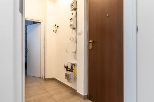a hallway with a room with a phone on the wall at [20 minuti dal Duomo] Milano Smart Apartment in Sesto San Giovanni