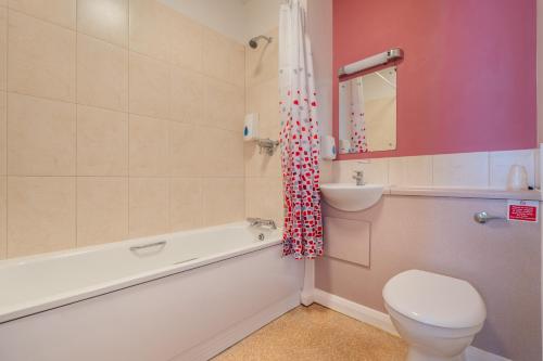 a bathroom with a toilet and a sink and a bath tub at Wookey Hole Hotel in Wells