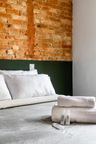 a bed with two remotes on top of it at ZEST Teodoro in Sao Paulo