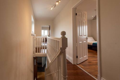 a hallway with a staircase leading to a bedroom at Pass the Keys Charming Cottage Stunning Views in Cheswardine