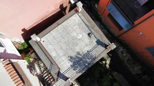 an overhead view of a tennis net in front of a building at La Bretonne in Feriolo