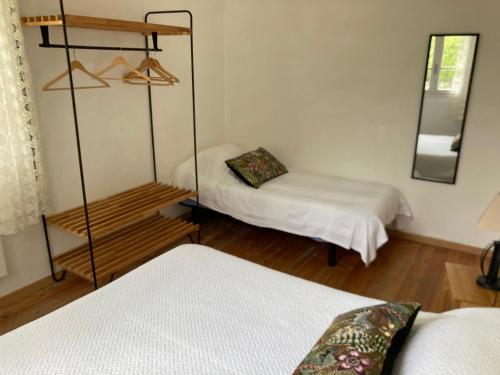 a room with two beds and a mirror at Casa Bauxells in Sahorre