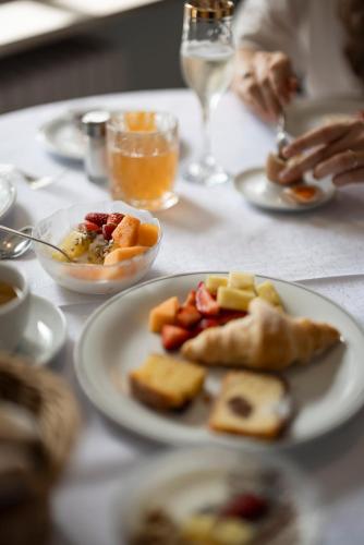a table with plates of food on top of it at Weingarten Terlan - Rooms & Breakfast in Terlano