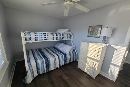 a bedroom with a bunk bed and a dresser at Direct Gulf Views with Deeded Beach Access (#17) - Sleeps 7 in Gulf Shores