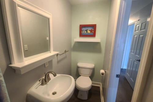 a bathroom with a white toilet and a sink at Direct Gulf Views with Deeded Beach Access (#17) - Sleeps 7 in Gulf Shores