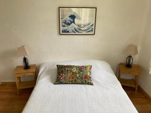 a bed with a pillow on it with two tables at Casa Bauxells in Sahorre