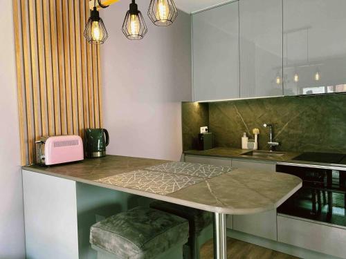a kitchen with a counter with a table in it at 150m To Beach-cosy Studiohistoric Oldtown in Cascais