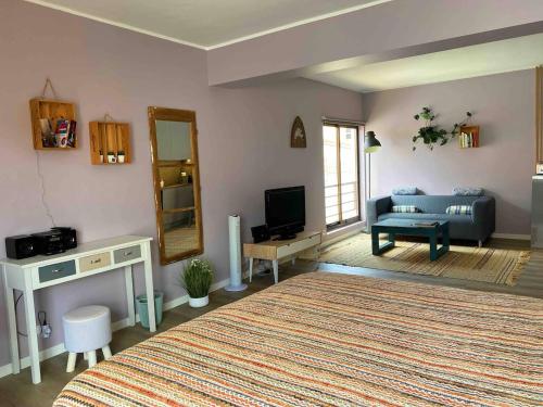 a living room with a bed and a couch at 150m To Beach-cosy Studiohistoric Oldtown in Cascais
