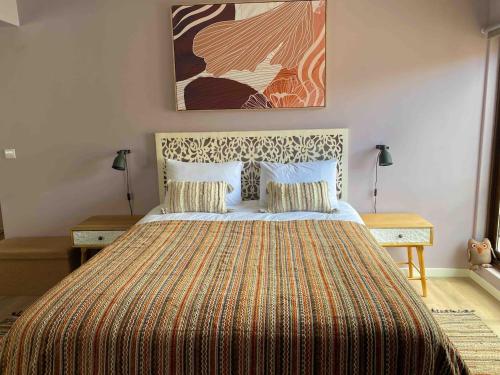a bedroom with a large bed with a large blanket at 150m To Beach-cosy Studiohistoric Oldtown in Cascais