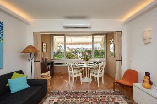 a living room with a table and a dining room at Sea View 2 Mins Walk To Beach And Estoril Casino in Estoril