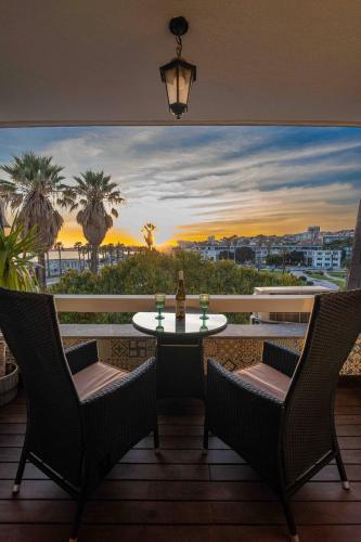 a balcony with a table and chairs and a view of the ocean at Sea View W Balcony 2 Mins Walk To Beach & Casino in Estoril