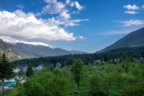 a view of a valley with mountains in the background at Tripli Hotels Namaste Manali in Manāli