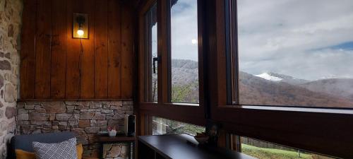 a room with two windows with a view of a mountain at CASA RURAL Urruska in Elizondo