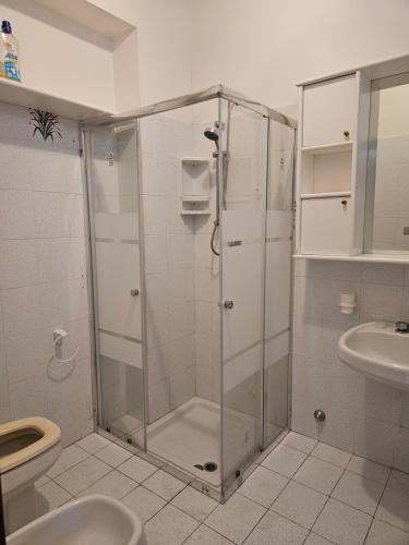 a bathroom with a shower with a toilet and a sink at CASA VACANZE DONNA YULIYA in Letojanni