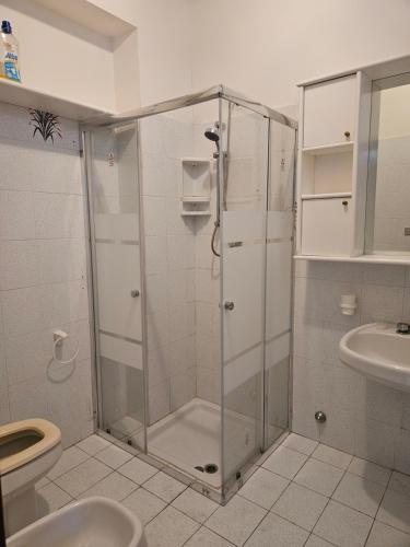 a bathroom with a shower with a toilet and a sink at Casa Yuliya in Letojanni