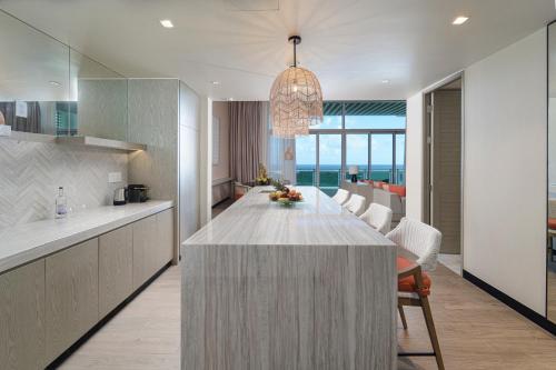 a kitchen and dining room with a large marble table at Wyndham Grand Barbados Sam Lords Castle All Inclusive Resort in Saint Philip