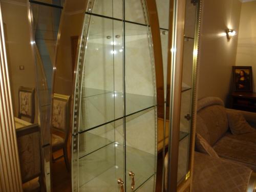 eine Glasdusche im Wohnzimmer mit Sofa in der Unterkunft Luxury Versailles Apartments Center Opera in Burgas City