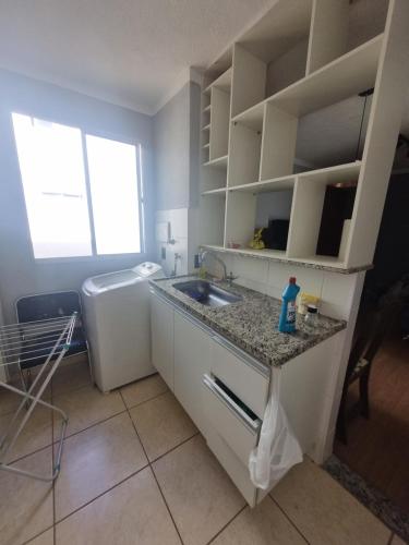 a kitchen with a sink and a counter top at Apartamento araraquara in Araraquara