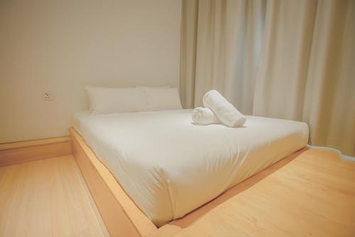 a white bed with a towel on it in a room at Double H Boutique Hotel in Kuala Terengganu